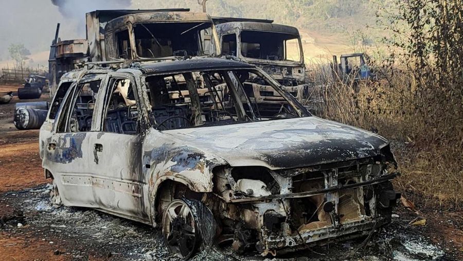 In this photo provided by the Karenni Nationalities Defense Force (KNDF), vehicles smolder in Hpruso township, Kayah state, Myanmar, Friday, Dec. 24, 2021. Myanmar government troops rounded up villagers, some believed to be women and children, fatally shot more than 30 and set the bodies on fire, a witness and other reports said Saturday. (KNDF via AP)