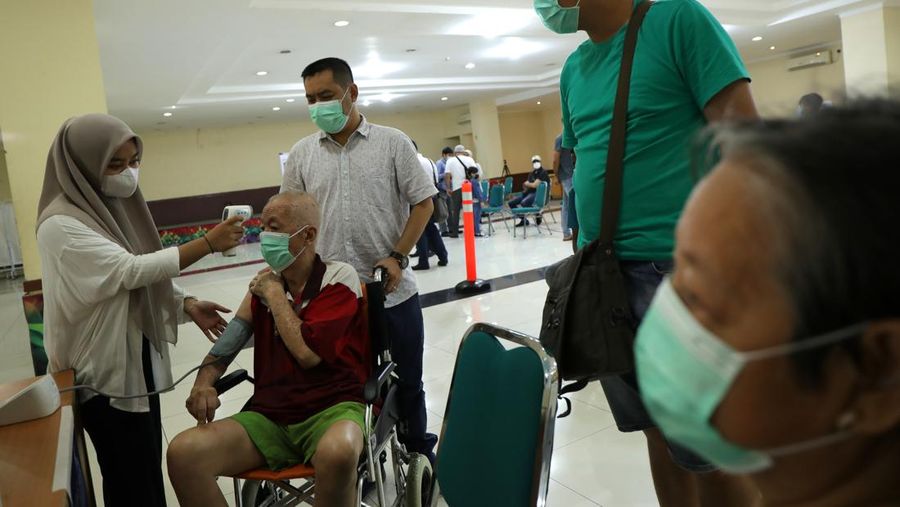People line up for a free COVID-19 rapid test at a gas station in the Reseda section of Los Angeles on Sunday, Dec. 26, 2021, as California braces for a post-holiday virus surge. (AP Photo/Richard Vogel)