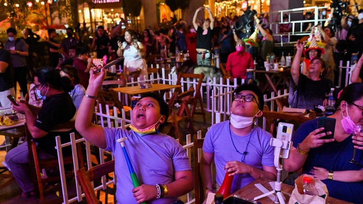 Orang-orang menonton pertunjukan kembang api selama perayaan Tahun Baru di Eastwood Mall, di Quezon City, Filipina (1/1/2022). (REUTERS/Lisa Marie David)