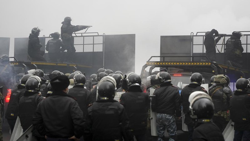 Pasukan kepolisian berjaga saat sejumlah warga berdemo memprotes pemerintah setelah keputusan menaikkan batas harga bahan bakar gas cair di Almaty, Kazakhstan, Kamis (6/1/2022). (REUTERS/Mariya Gordeyeva)