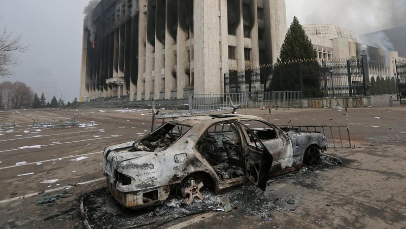 Pasukan kepolisian berjaga saat sejumlah warga berdemo memprotes pemerintah setelah keputusan menaikkan batas harga bahan bakar gas cair di Almaty, Kazakhstan, Kamis (6/1/2022). (REUTERS/Mariya Gordeyeva)
