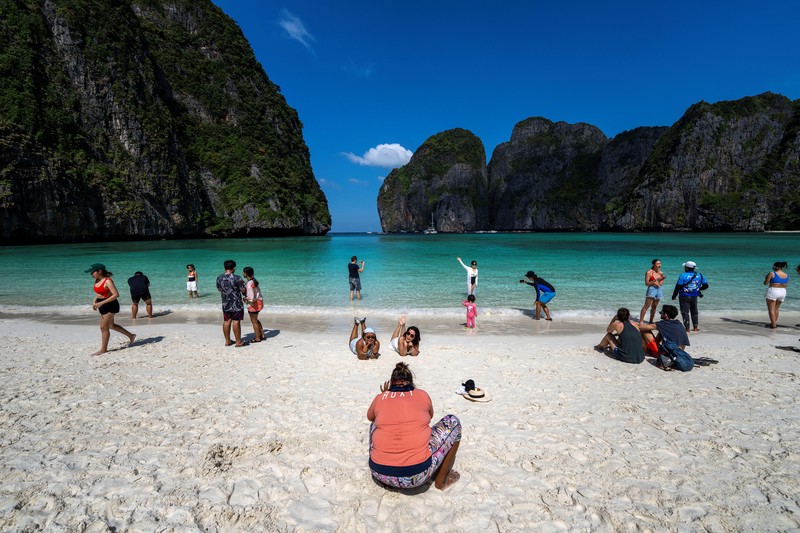 Turis mengunjungi teluk Maya di provinsi Krabi, Thailand Turis mengunjungi teluk Maya setelah Thailand membuka kembali pantainya yang terkenal di dunia setelah ditutup selama lebih dari tiga tahun untuk pemulihan ekosistem dari dampak overtourism di provinsi Krabi, Thailand, Selasa (3/1/2022). (REUTERS/Athit Perawongmetha)