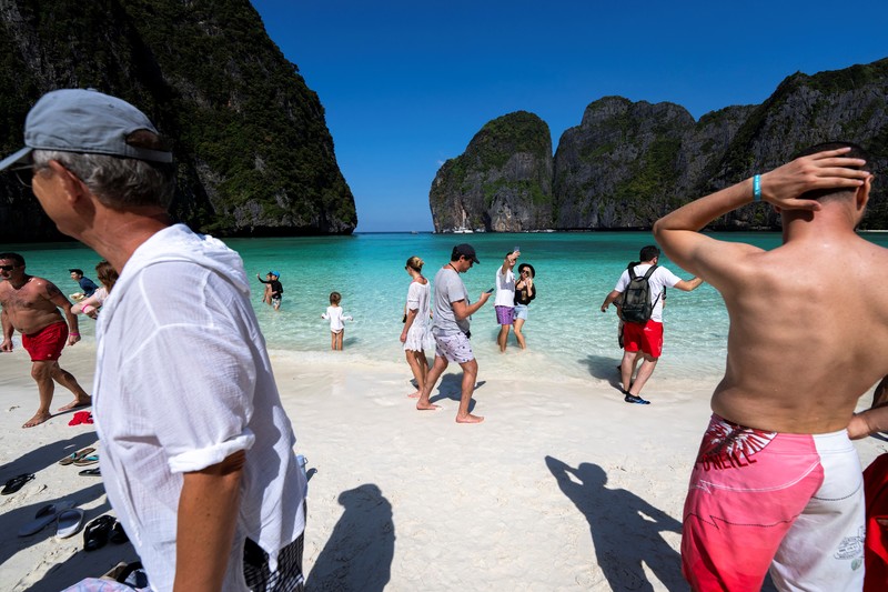 Turis mengunjungi teluk Maya di provinsi Krabi, Thailand Turis mengunjungi teluk Maya setelah Thailand membuka kembali pantainya yang terkenal di dunia setelah ditutup selama lebih dari tiga tahun untuk pemulihan ekosistem dari dampak overtourism di provinsi Krabi, Thailand, Selasa (3/1/2022). (REUTERS/Athit Perawongmetha)