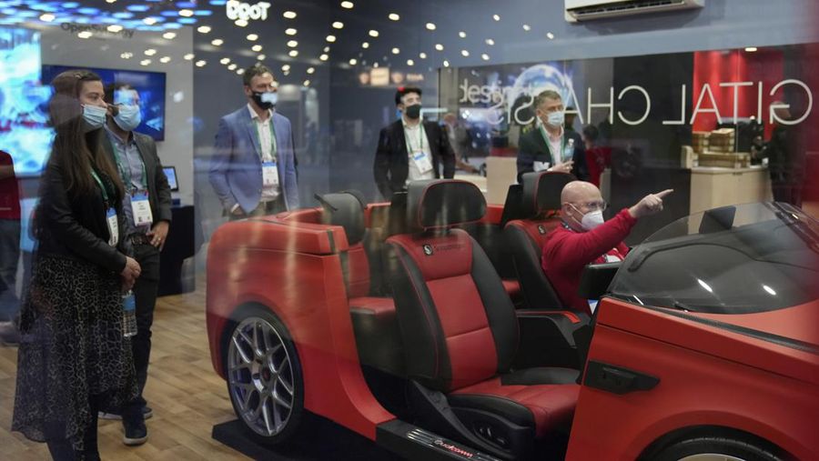 FILE - Kelly Taylor tries out a metaverse virtual shopping experience at the LOTTE Data Communication booth during the CES tech show Wednesday, Jan. 5, 2022, in Las Vegas. The thousands of people who gathered in Las Vegas for this week's CES gadget show were a fraction of the usual crowd for the influential tech conference, the event's organizer said Friday, Jan. 7. The Consumer Technology Association said on the show's closing day that more than 40,000 people attended the multi-day event on the Las Vegas Strip. (AP Photo/Joe Buglewicz, File)