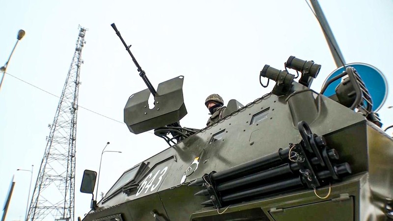 In this image taken from footage provided by the RU-RTR Russian television, Military vehicles of Russian peacekeepers parked waiting to be uploaded on Russian military planes at an airfield in Russia, Friday, Jan. 7, 2022. Over 70 cargo planes are being deployed in Russia's peacekeeping mission in Kazakhstan according to the Defense Ministry chief spokesman's briefing on Friday, after the worst street protests since the country gained independence three decades ago. The demonstrations began over a near-doubling of prices for a type of vehicle fuel and quickly spread across the country, reflecting wider discontent over the rule of the same party since independence. (RU-RTR Russian Television via AP)