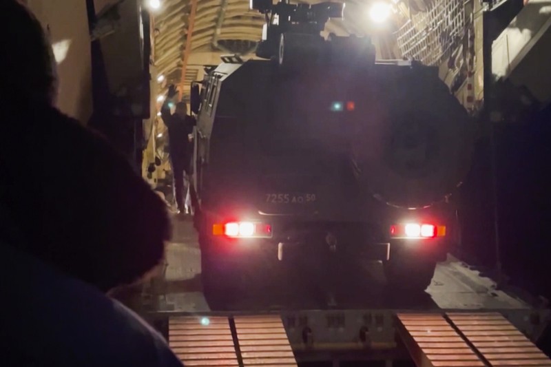 In this image taken from footage provided by the RU-RTR Russian television, Military vehicles of Russian peacekeepers parked waiting to be uploaded on Russian military planes at an airfield in Russia, Friday, Jan. 7, 2022. Over 70 cargo planes are being deployed in Russia's peacekeeping mission in Kazakhstan according to the Defense Ministry chief spokesman's briefing on Friday, after the worst street protests since the country gained independence three decades ago. The demonstrations began over a near-doubling of prices for a type of vehicle fuel and quickly spread across the country, reflecting wider discontent over the rule of the same party since independence. (RU-RTR Russian Television via AP)