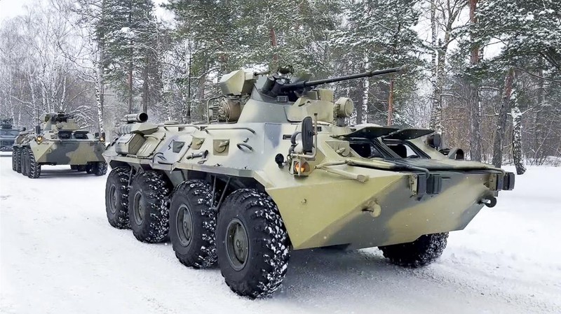 In this image taken from footage provided by the RU-RTR Russian television, Military vehicles of Russian peacekeepers parked waiting to be uploaded on Russian military planes at an airfield in Russia, Friday, Jan. 7, 2022. Over 70 cargo planes are being deployed in Russia's peacekeeping mission in Kazakhstan according to the Defense Ministry chief spokesman's briefing on Friday, after the worst street protests since the country gained independence three decades ago. The demonstrations began over a near-doubling of prices for a type of vehicle fuel and quickly spread across the country, reflecting wider discontent over the rule of the same party since independence. (RU-RTR Russian Television via AP)