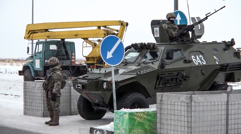In this image taken from footage provided by the RU-RTR Russian television, Military vehicles of Russian peacekeepers parked waiting to be uploaded on Russian military planes at an airfield in Russia, Friday, Jan. 7, 2022. Over 70 cargo planes are being deployed in Russia's peacekeeping mission in Kazakhstan according to the Defense Ministry chief spokesman's briefing on Friday, after the worst street protests since the country gained independence three decades ago. The demonstrations began over a near-doubling of prices for a type of vehicle fuel and quickly spread across the country, reflecting wider discontent over the rule of the same party since independence. (RU-RTR Russian Television via AP)