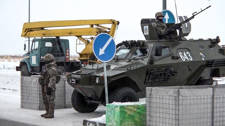 In this image taken from footage provided by the RU-RTR Russian television, Military vehicles of Russian peacekeepers parked waiting to be uploaded on Russian military planes at an airfield in Russia, Friday, Jan. 7, 2022. Over 70 cargo planes are being deployed in Russia's peacekeeping mission in Kazakhstan according to the Defense Ministry chief spokesman's briefing on Friday, after the worst street protests since the country gained independence three decades ago. The demonstrations began over a near-doubling of prices for a type of vehicle fuel and quickly spread across the country, reflecting wider discontent over the rule of the same party since independence. (RU-RTR Russian Television via AP)