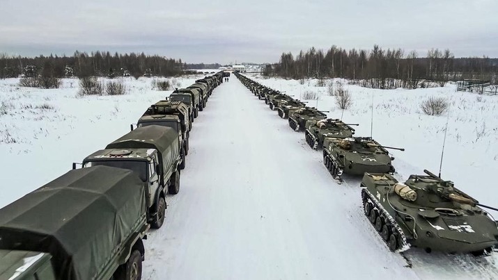 In this image taken from footage provided by the RU-RTR Russian television, Military vehicles of Russian peacekeepers parked waiting to be uploaded on Russian military planes at an airfield in Russia, Friday, Jan. 7, 2022. Over 70 cargo planes are being deployed in Russia's peacekeeping mission in Kazakhstan according to the Defense Ministry chief spokesman's briefing on Friday, after the worst street protests since the country gained independence three decades ago. The demonstrations began over a near-doubling of prices for a type of vehicle fuel and quickly spread across the country, reflecting wider discontent over the rule of the same party since independence. (RU-RTR Russian Television via AP)