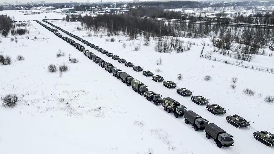 In this image taken from footage provided by the RU-RTR Russian television, Military vehicles of Russian peacekeepers parked waiting to be uploaded on Russian military planes at an airfield in Russia, Friday, Jan. 7, 2022. Over 70 cargo planes are being deployed in Russia's peacekeeping mission in Kazakhstan according to the Defense Ministry chief spokesman's briefing on Friday, after the worst street protests since the country gained independence three decades ago. The demonstrations began over a near-doubling of prices for a type of vehicle fuel and quickly spread across the country, reflecting wider discontent over the rule of the same party since independence. (RU-RTR Russian Television via AP)