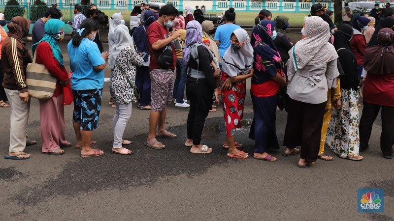 Sejumlah warga antre membeli minyak goreng kemasan saat operasi pasar minyak goreng murah di Halaman Kantor Kecamatan Pamulang, Tangerang Selatan, Banten, Selasa (11/1/2022). (CNBC Indonesia/Muhammad Sabki)