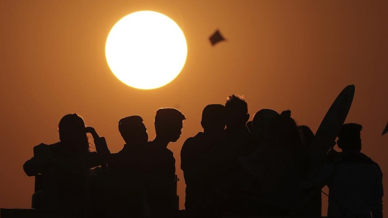 Hindu devotees crowd the Sangam, the confluence of three rivers — the Ganges, the Yamuna and the mythical Saraswati, to take a ritualistic bath during Makar Sankranti festival that falls during the annual traditional fair of Magh Mela festival, one of the most sacred pilgrimages in Hinduism, in Prayagraj, India. Friday, Jan. 14, 2022. Tens of thousands of devout Hindus, led by heads of monasteries and ash-smeared ascetics, took a holy dip into the frigid waters on Friday despite rising COVID-19 infections in the country. (AP Photo/Rajesh Kumar Singh)