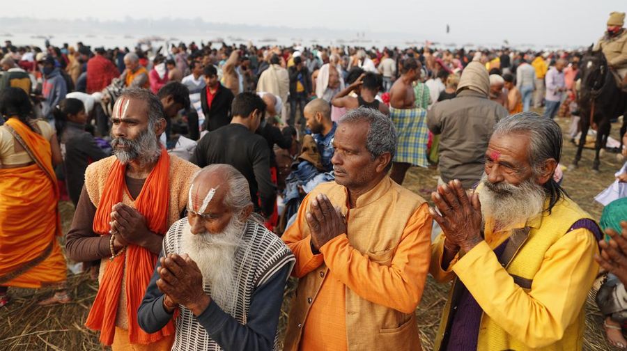 Hindu devotees crowd the Sangam, the confluence of three rivers — the Ganges, the Yamuna and the mythical Saraswati, to take a ritualistic bath during Makar Sankranti festival that falls during the annual traditional fair of Magh Mela festival, one of the most sacred pilgrimages in Hinduism, in Prayagraj, India. Friday, Jan. 14, 2022. Tens of thousands of devout Hindus, led by heads of monasteries and ash-smeared ascetics, took a holy dip into the frigid waters on Friday despite rising COVID-19 infections in the country. (AP Photo/Rajesh Kumar Singh)