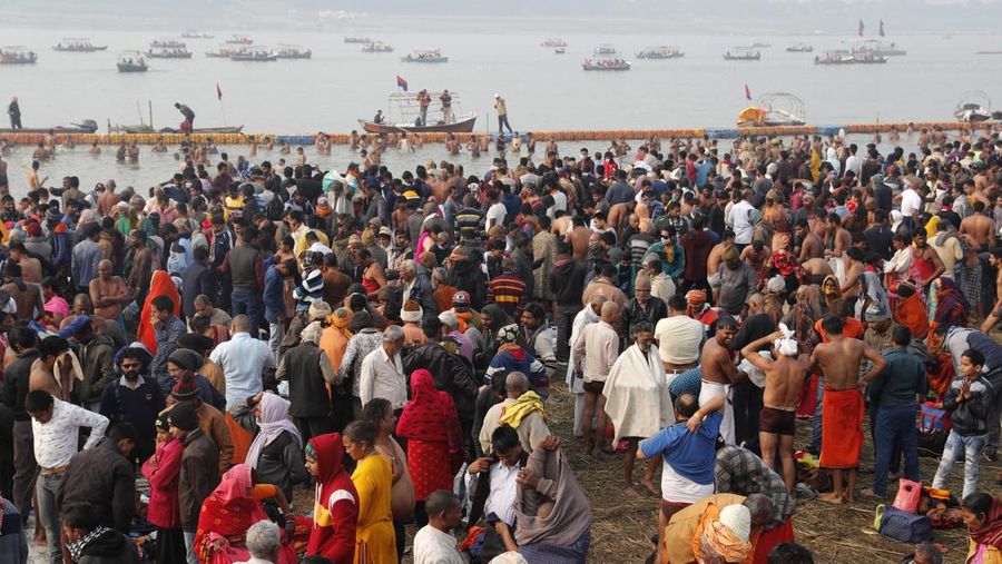 Hindu devotees crowd the Sangam, the confluence of three rivers — the Ganges, the Yamuna and the mythical Saraswati, to take a ritualistic bath during Makar Sankranti festival that falls during the annual traditional fair of Magh Mela festival, one of the most sacred pilgrimages in Hinduism, in Prayagraj, India. Friday, Jan. 14, 2022. Tens of thousands of devout Hindus, led by heads of monasteries and ash-smeared ascetics, took a holy dip into the frigid waters on Friday despite rising COVID-19 infections in the country. (AP Photo/Rajesh Kumar Singh)