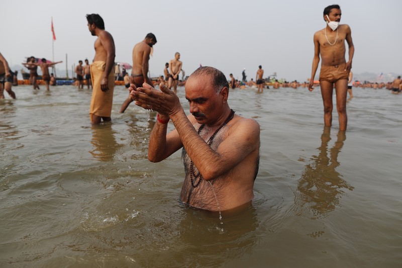 India Virus Outbreak Hindu Festival Hindu devotees crowd the Sangam, the confluence of three rivers — the Ganges, the Yamuna and the mythical Saraswati, to take a ritualistic bath during Makar Sankranti festival that falls during the annual traditional fair of Magh Mela festival, one of the most sacred pilgrimages in Hinduism, in Prayagraj, India. Friday, Jan. 14, 2022. Tens of thousands of devout Hindus, led by heads of monasteries and ash-smeared ascetics, took a holy dip into the frigid waters on Friday despite rising COVID-19 infections in the country. (AP Photo/Rajesh Kumar Singh)