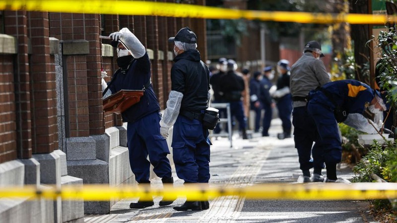 Police officers inspect at the site where a stabbing incident happened at an entrance gate of Tokyo University in Tokyo, Japan January 15, 2022. REUTERS/Issei Kato