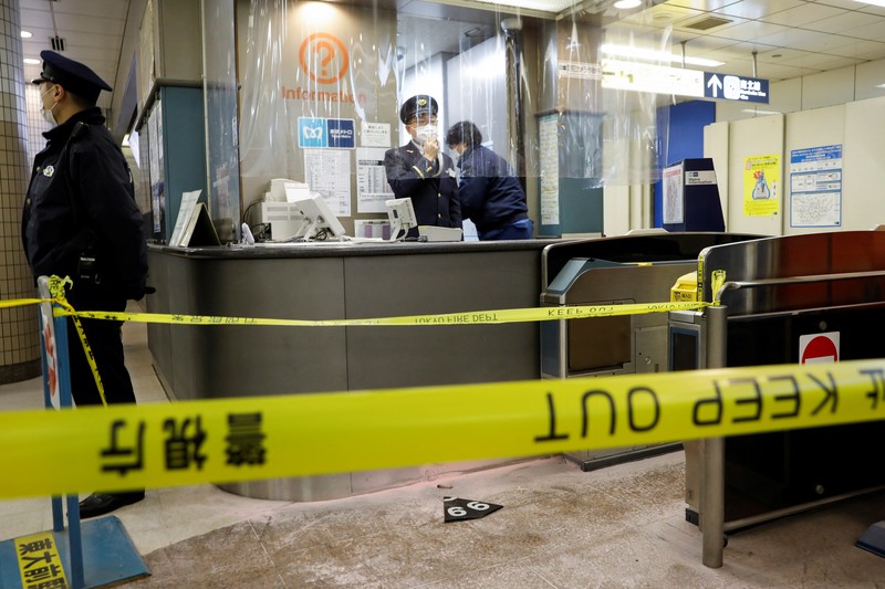 JAPAN-STABBING/ Police officers inspect at the site where a stabbing incident happened at an entrance gate of Tokyo University in Tokyo, Japan January 15, 2022. REUTERS/Issei Kato