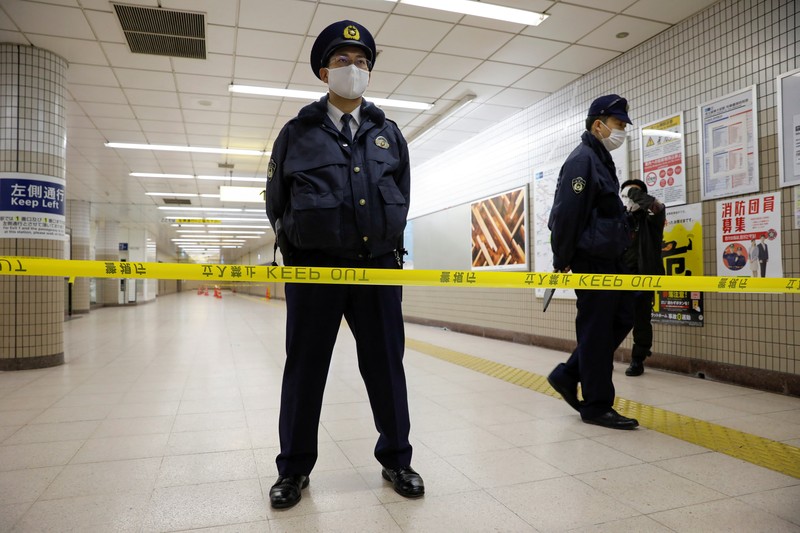 JAPAN-STABBING/ Police officers inspect at the site where a stabbing incident happened at an entrance gate of Tokyo University in Tokyo, Japan January 15, 2022. REUTERS/Issei Kato