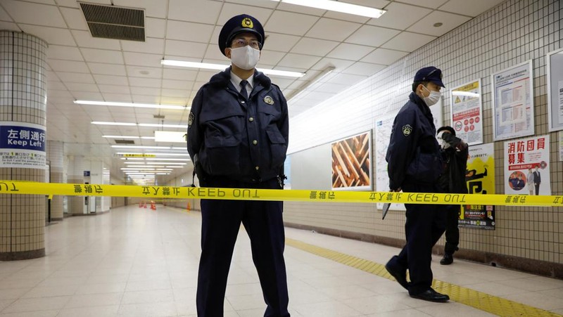 Police officers inspect at the site where a stabbing incident happened at an entrance gate of Tokyo University in Tokyo, Japan January 15, 2022. REUTERS/Issei Kato