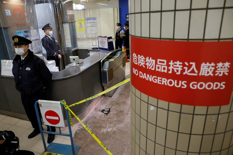 Police officers inspect at the site where a stabbing incident happened at an entrance gate of Tokyo University in Tokyo, Japan January 15, 2022. REUTERS/Issei Kato