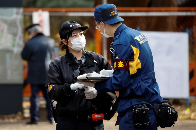 Police officers inspect at the site where a stabbing incident happened at an entrance gate of Tokyo University in Tokyo, Japan January 15, 2022. REUTERS/Issei Kato