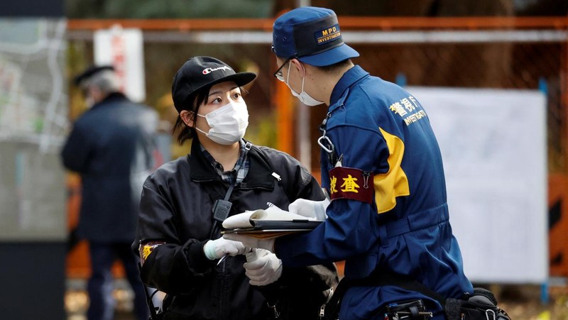 Police officers inspect at the site where a stabbing incident happened at an entrance gate of Tokyo University in Tokyo, Japan January 15, 2022. REUTERS/Issei Kato
