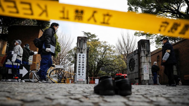 Police officers inspect at the site where a stabbing incident happened at an entrance gate of Tokyo University in Tokyo, Japan January 15, 2022. REUTERS/Issei Kato
