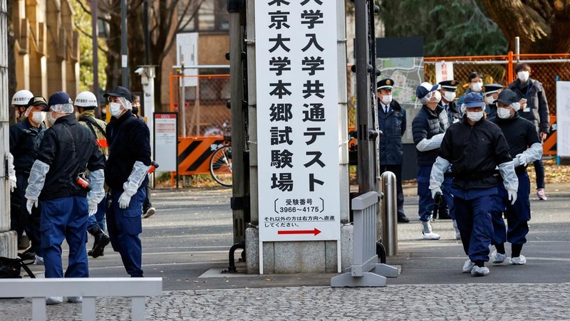 Police officers inspect at the site where a stabbing incident happened at an entrance gate of Tokyo University in Tokyo, Japan January 15, 2022. REUTERS/Issei Kato
