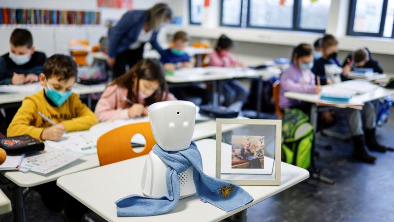 A seven-year-old schoolboy Joshua attends his school lesson via a robot avatar, placed in his classroom, in Berlin, Germany January 13, 2022. Picture taken January 13, 2022. REUTERS/Hannibal Hanschke