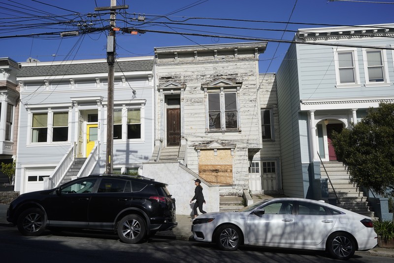 San Francisco $2 Million Fixer A pedestrian walks a dog past a recently sold Victorian home in San Francisco, Friday, Jan. 14, 2022. The decaying, 122-year-old Victorian marketed as
