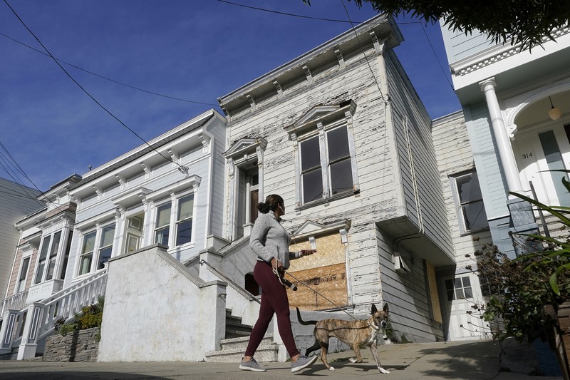 San Francisco $2 Million Fixer A pedestrian walks a dog past a recently sold Victorian home in San Francisco, Friday, Jan. 14, 2022. The decaying, 122-year-old Victorian marketed as