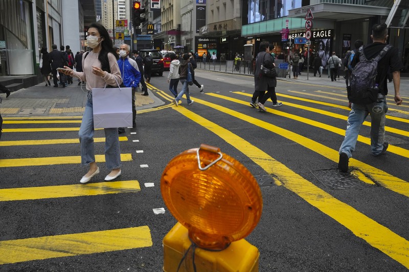 A staffer from the Agriculture, Fisheries and Conservation Department walks past a pet shop which was closed after some pet hamsters were, authorities said, tested positive for the coronavirus, in Hong Kong, Tuesday, Jan. 18, 2022. Hong Kong authorities said Tuesday that they will cull some 2,000 hamsters after several of the rodents tested positive for delta variant at the pet store where an infected employee was working. (AP Photo/Kin Cheung)