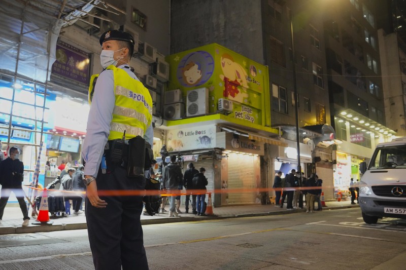 Virus Outbreak Hong Kong A staffer from the Agriculture, Fisheries and Conservation Department walks past a pet shop which was closed after some pet hamsters were, authorities said, tested positive for the coronavirus, in Hong Kong, Tuesday, Jan. 18, 2022. Hong Kong authorities said Tuesday that they will cull some 2,000 hamsters after several of the rodents tested positive for delta variant at the pet store where an infected employee was working. (AP Photo/Kin Cheung)