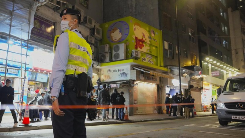 A staffer from the Agriculture, Fisheries and Conservation Department walks past a pet shop which was closed after some pet hamsters were, authorities said, tested positive for the coronavirus, in Hong Kong, Tuesday, Jan. 18, 2022. Hong Kong authorities said Tuesday that they will cull some 2,000 hamsters after several of the rodents tested positive for delta variant at the pet store where an infected employee was working. (AP Photo/Kin Cheung)