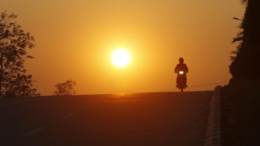 A man rides his motorcycle during sunset in Naypyitaw, Myanmar, Monday, Feb. 1, 2021. Myanmar military television said Monday that the military was taking control of the country for one year, while reports said many of the country's senior politicians including Aung San Suu Kyi had been detained. (AP Photo)