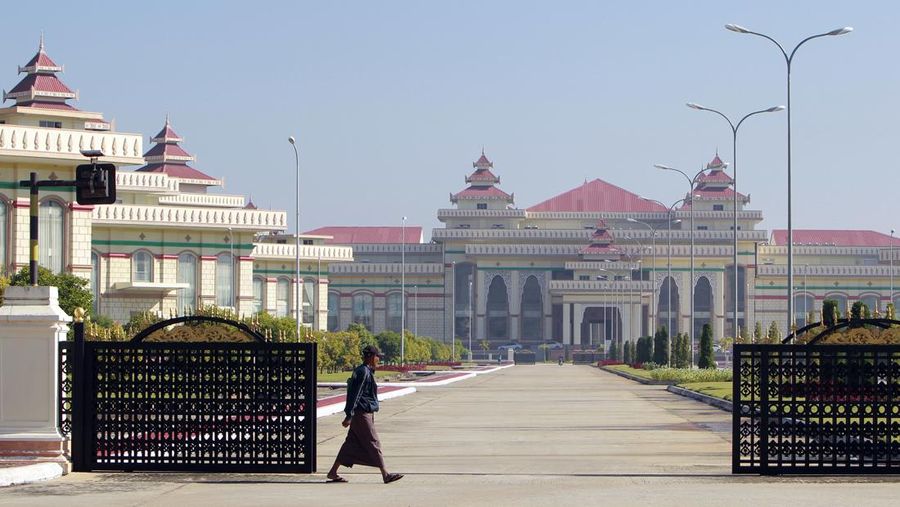A man walks in front of Parliament Building in Naypyitaw, Myanmar Wednesday, Jan. 24, 2018. (AP Photo/Aung Shine Oo)