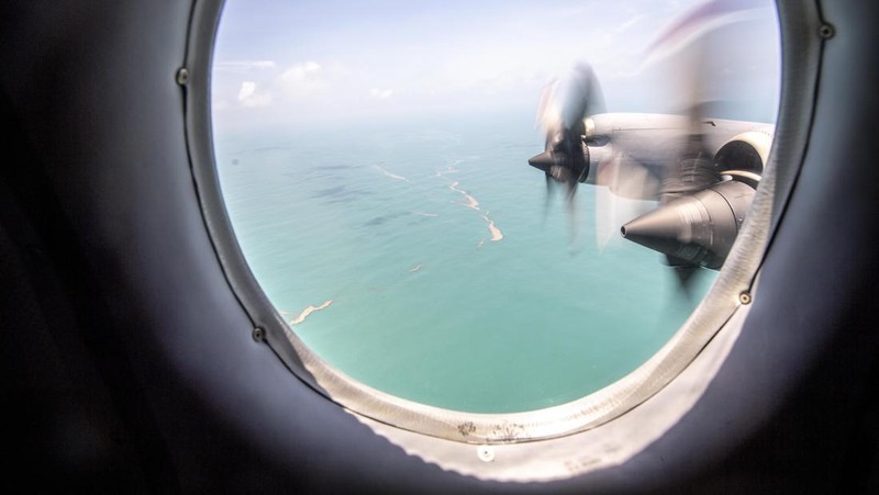 A general view from a New Zealand Defence Force P-3K2 Orion surveillance flight shows heavy ash fall over Nomuka in Tonga after the Pacific island nation was hit by a tsunami triggered by an undersea volcanic eruption January 17, 2022. Picture taken January 17, 2022. New Zealand Defence Force/Handout via REUTERS ATTENTION EDITORS - THIS IMAGE WAS PROVIDED BY A THIRD PARTY. NO RESALES. NO ARCHIVE.