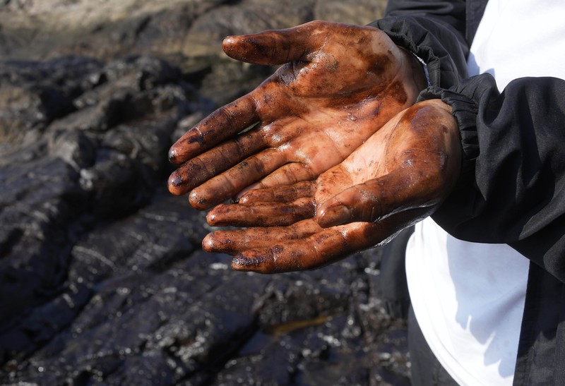 Peru Oil Spill Tonga Oil floats in the water off Cavero beach in Ventanilla, Callao, Peru, Tuesday, Jan. 18, 2022, after high waves attributed to the eruption of an undersea volcano in Tonga caused an oil spill. The Peruvian Civil Defense Institute said in a press release that a ship was loading oil into La Pampilla refinery on the Pacific coast on Sunday when strong waves moved the boat and caused the spill. (AP Photo/Martin Mejia)