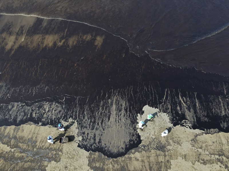 Peru Oil Spill Tonga Oil floats in the water off Cavero beach in Ventanilla, Callao, Peru, Tuesday, Jan. 18, 2022, after high waves attributed to the eruption of an undersea volcano in Tonga caused an oil spill. The Peruvian Civil Defense Institute said in a press release that a ship was loading oil into La Pampilla refinery on the Pacific coast on Sunday when strong waves moved the boat and caused the spill. (AP Photo/Martin Mejia)