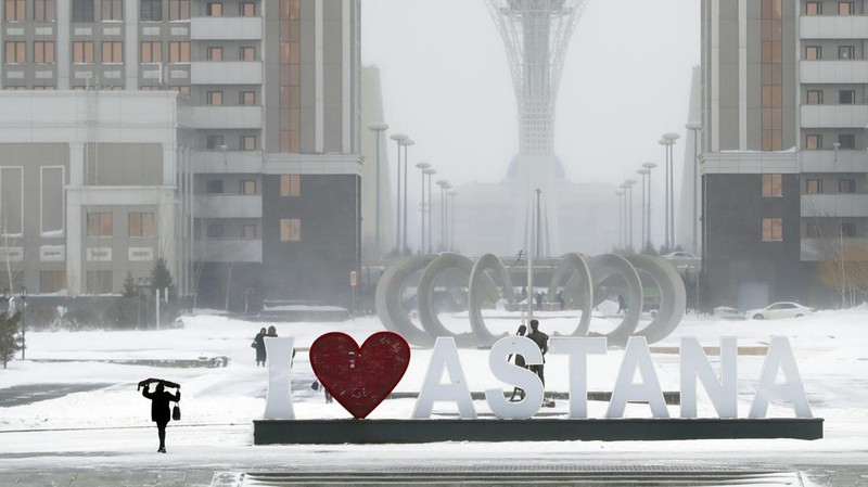 FILE - In this Wednesday, Jan. 25, 2017 file photo, residents walk in a street in Astana, Kazakhstan. The parliament of the Central Asian nation of Kazakhstan on Wednesday March 20, 2019, voted to rename the country's capital Nursultan, after the outgoing longtime leader. (AP Photo/Sergei Grits, File)