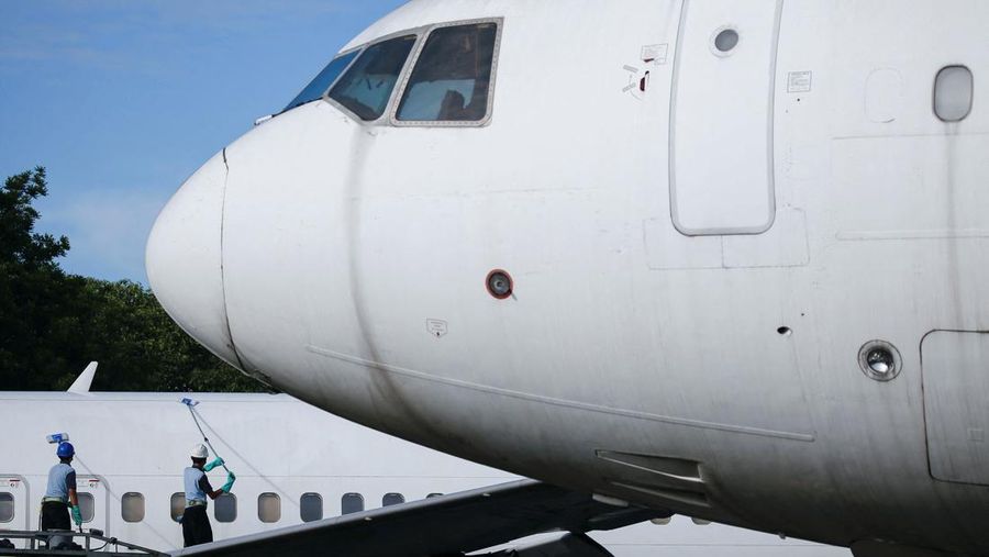 Workers clean a Garuda Indonesia's aircraft at the Garuda Maintenance Facility (GMF) AeroAsia, at Soekarno-Hatta International airport near Jakarta, Indonesia, January 21, 2022. REUTERS/Willy Kurniawan