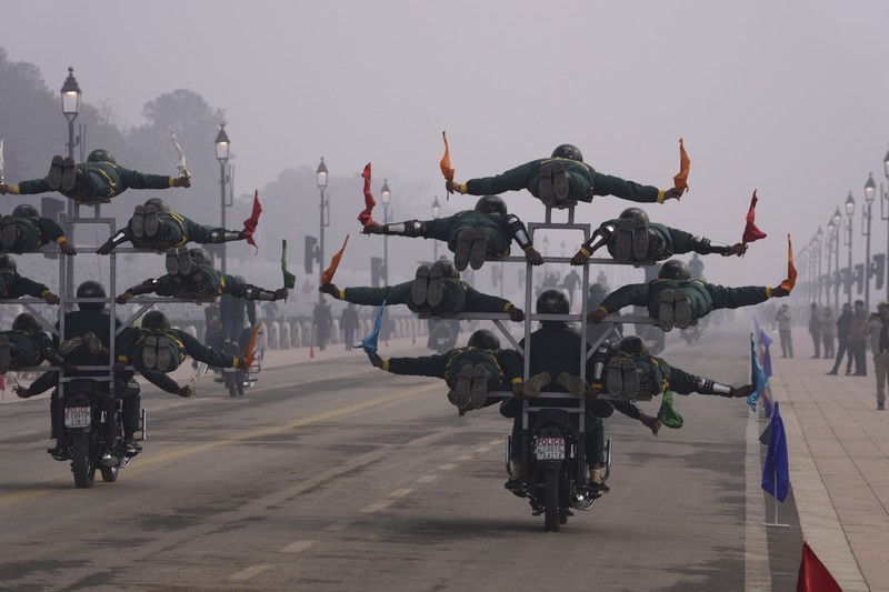 An all women team from Indian Border Security force displays their skill on a moving motorcycle during the rehearsal for the upcoming Republic Day parade at the Raisina hills, the government seat of power, in New Delhi, India, Thursday, Jan. 20, 2022. India celebrates Republic Day on Jan. 26, highlighted by a march past by different branches of the military as well as a display of arms and missiles. (AP Photo/Manish Swarup)