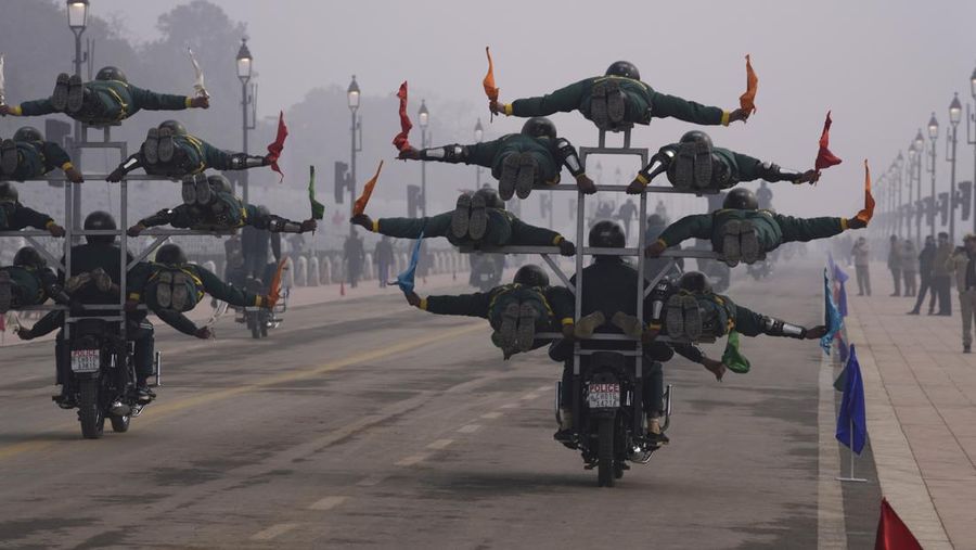 An all women team from Indian Border Security force displays their skill on a moving motorcycle during the rehearsal for the upcoming Republic Day parade at the Raisina hills, the government seat of power, in New Delhi, India, Thursday, Jan. 20, 2022. India celebrates Republic Day on Jan. 26, highlighted by a march past by different branches of the military as well as a display of arms and missiles. (AP Photo/Manish Swarup)