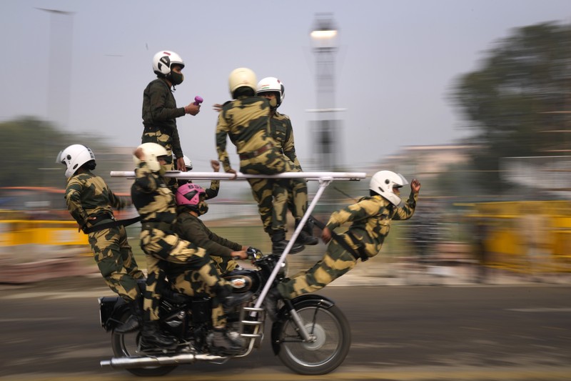 An all women team from Indian Border Security force displays their skill on a moving motorcycle during the rehearsal for the upcoming Republic Day parade at the Raisina hills, the government seat of power, in New Delhi, India, Thursday, Jan. 20, 2022. India celebrates Republic Day on Jan. 26, highlighted by a march past by different branches of the military as well as a display of arms and missiles. (AP Photo/Manish Swarup)