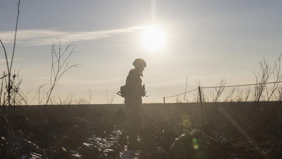 An Ukrainian soldier walks on the line of separation from pro-Russian rebels, in Mariupol, Donetsk region, Ukraine, Thursday, Jan. 20, 2022. President Joe Biden has warned Russia's Vladimir Putin that the U.S. could impose new sanctions against Russia if it takes further military action against Ukraine. U.S. Secretary of State Antony Blinken is warning of a unified,