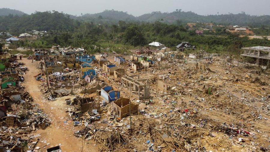 A view shows debris of houses and other buildings that were destroyed when a vehicle carrying mining explosives detonated along a road in Apiate, Ghana, January 21, 2022.  Picture taken with a drone. REUTERS/Cooper Inveen