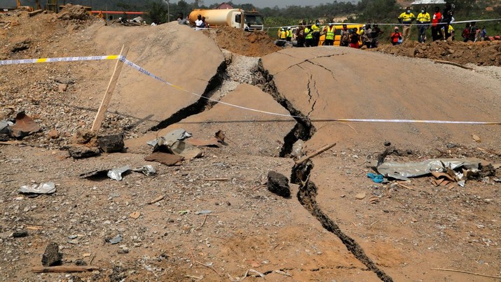 A view of a road that was damaged after a vehicle carrying mining explosives detonated along a road in Apiate, Ghana, January 21, 2022. REUTERS/Francis Kokoroko