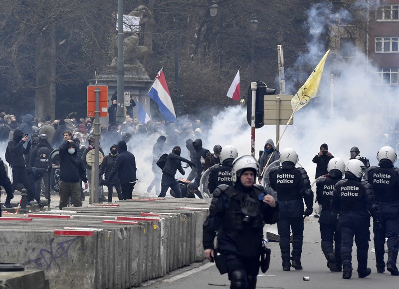 Demo Tolak Vaksin di Brussels Belgia Seorang pengunjuk rasa berbaris dengan salib di dekat markas besar Uni Eropa selama demonstrasi menentang vaksin COVID-19 di Brussels, Minggu (23/1/2022). Demonstran berkumpul di ibukota Belgia untuk memprotes apa yang mereka anggap sebagai tindakan yang terlalu ekstrem oleh pemerintah untuk memerangi COVID -19 pandemi, termasuk izin vaksin yang mengatur akses ke tempat dan kegiatan tertentu dan kemungkinan vaksin wajib. Cross berbunyi 'Kebenaran yang membuat kita dibohongi'. (AP Photo/Geert Vanden Wijngaert)