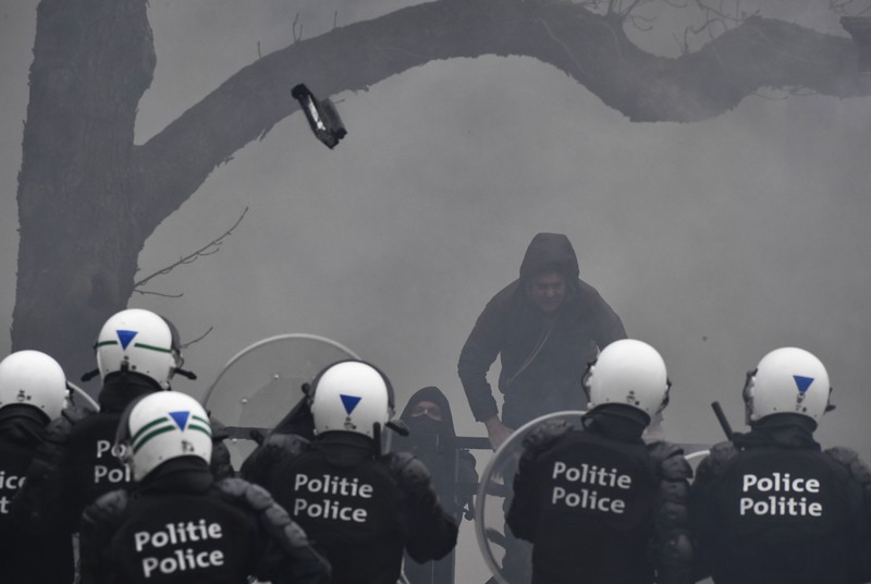 Seorang pengunjuk rasa berbaris dengan salib di dekat markas besar Uni Eropa selama demonstrasi menentang vaksin COVID-19 di Brussels, Minggu (23/1/2022). Demonstran berkumpul di ibukota Belgia untuk memprotes apa yang mereka anggap sebagai tindakan yang terlalu ekstrem oleh pemerintah untuk memerangi COVID -19 pandemi, termasuk izin vaksin yang mengatur akses ke tempat dan kegiatan tertentu dan kemungkinan vaksin wajib. Cross berbunyi 'Kebenaran yang membuat kita dibohongi'. (AP Photo/Geert Vanden Wijngaert)